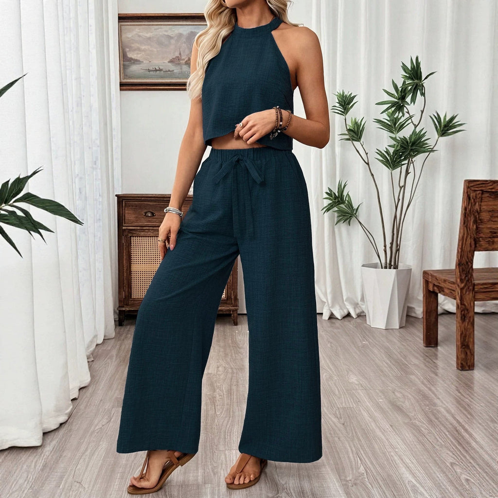 Women's casual two-piece set by FitiqueFit with halter neck cropped top and wide-leg pants, displayed on a model.