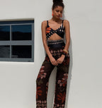 Women's sleeveless swimsuit top and wide-leg pants set by FitiqueFit, stylish swimwear for beach or poolside relaxation.