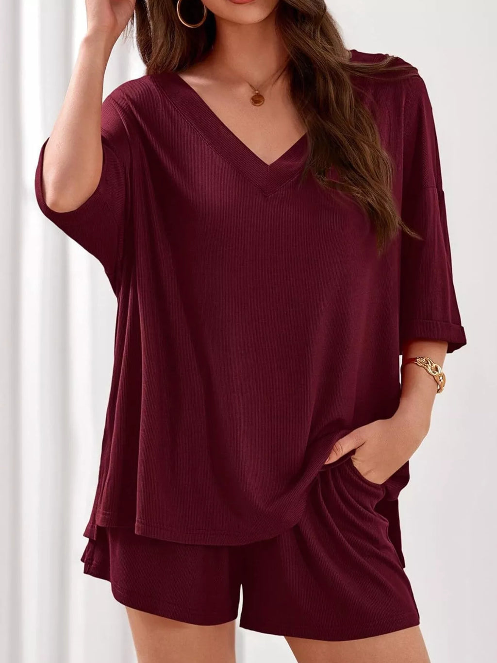 Women's casual V-neck top and shorts set in solid color, trendy two-piece outfit by Trendsi, perfect for relaxed everyday wear.