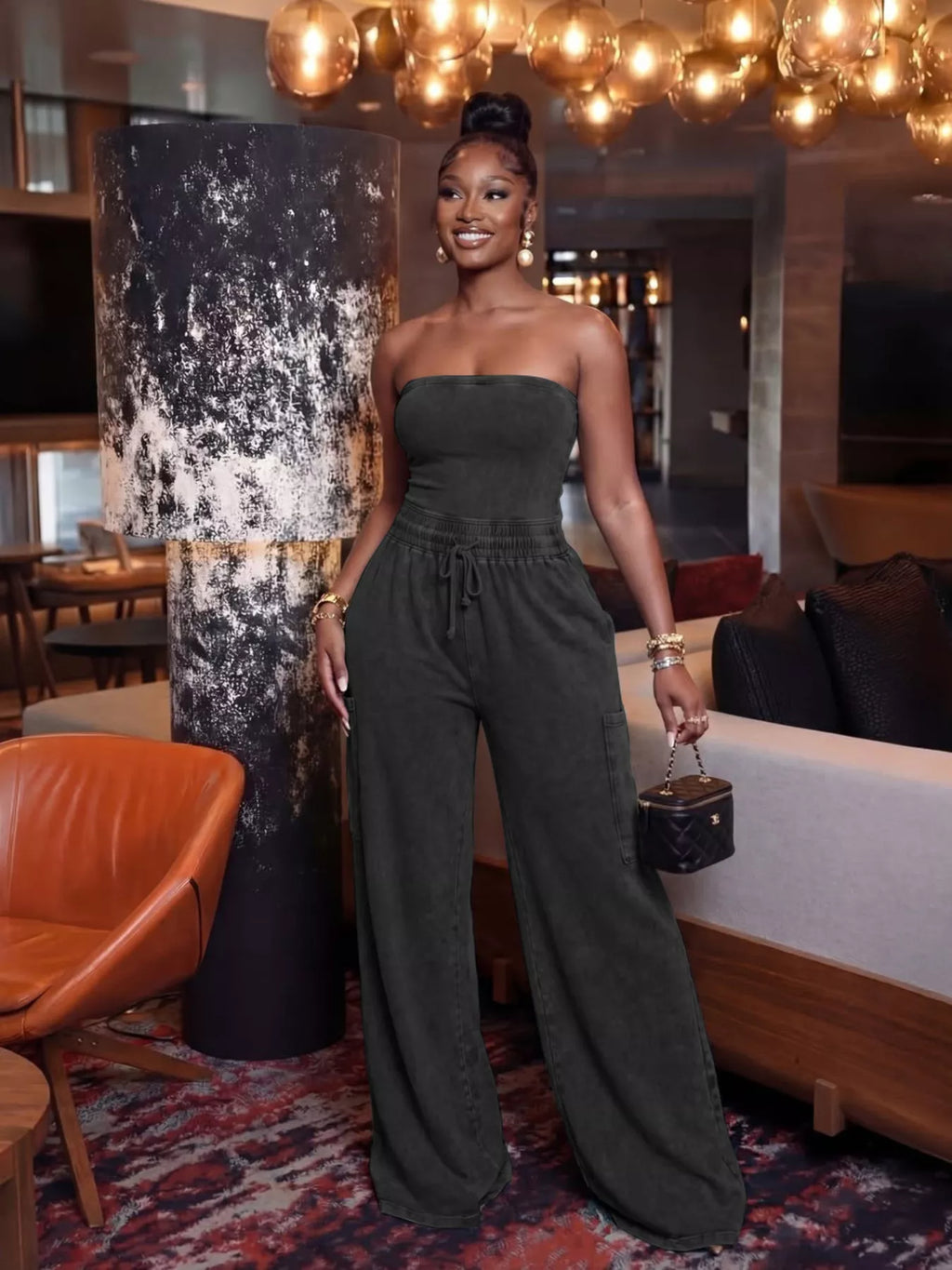 Strapless wide-leg jumpsuit with drawstring waist in black, from Plush Fashion Hub, styled with a fitted bodice and flowing pants.