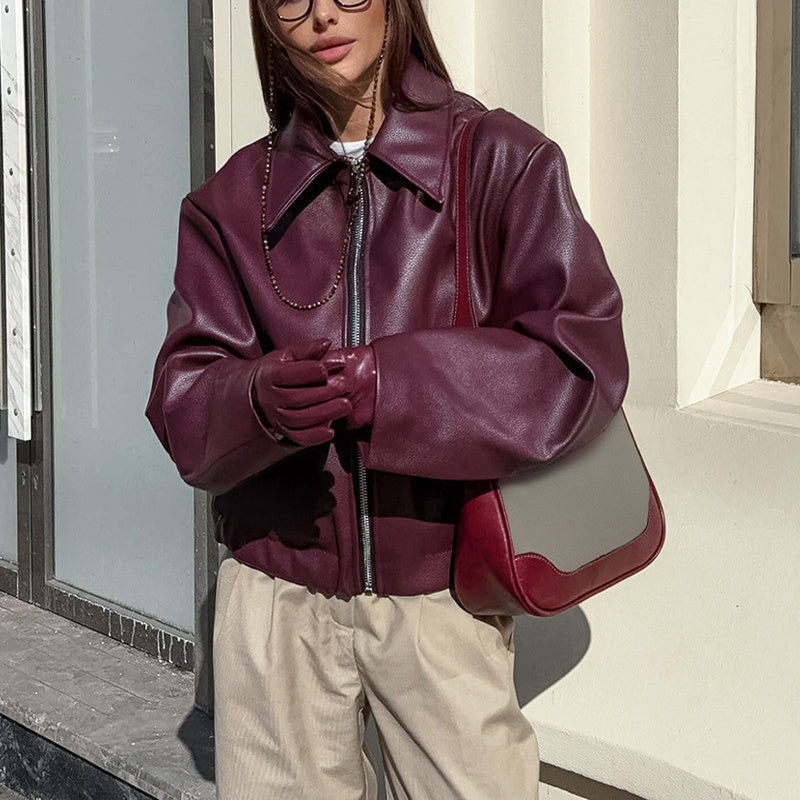 Vintage style women's faux leather jacket in solid color, featuring classic design and plush fashion details.