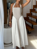 Elegant two-tone halter neck maxi dress with ruched design and pockets, by Plush Fashion Hub, shown in a flowing fabric style.