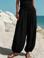 Plus size full size one-shoulder top and wide-leg pants set by Plush Fashion Hub, stylish piece pants set with a modern silhouette.