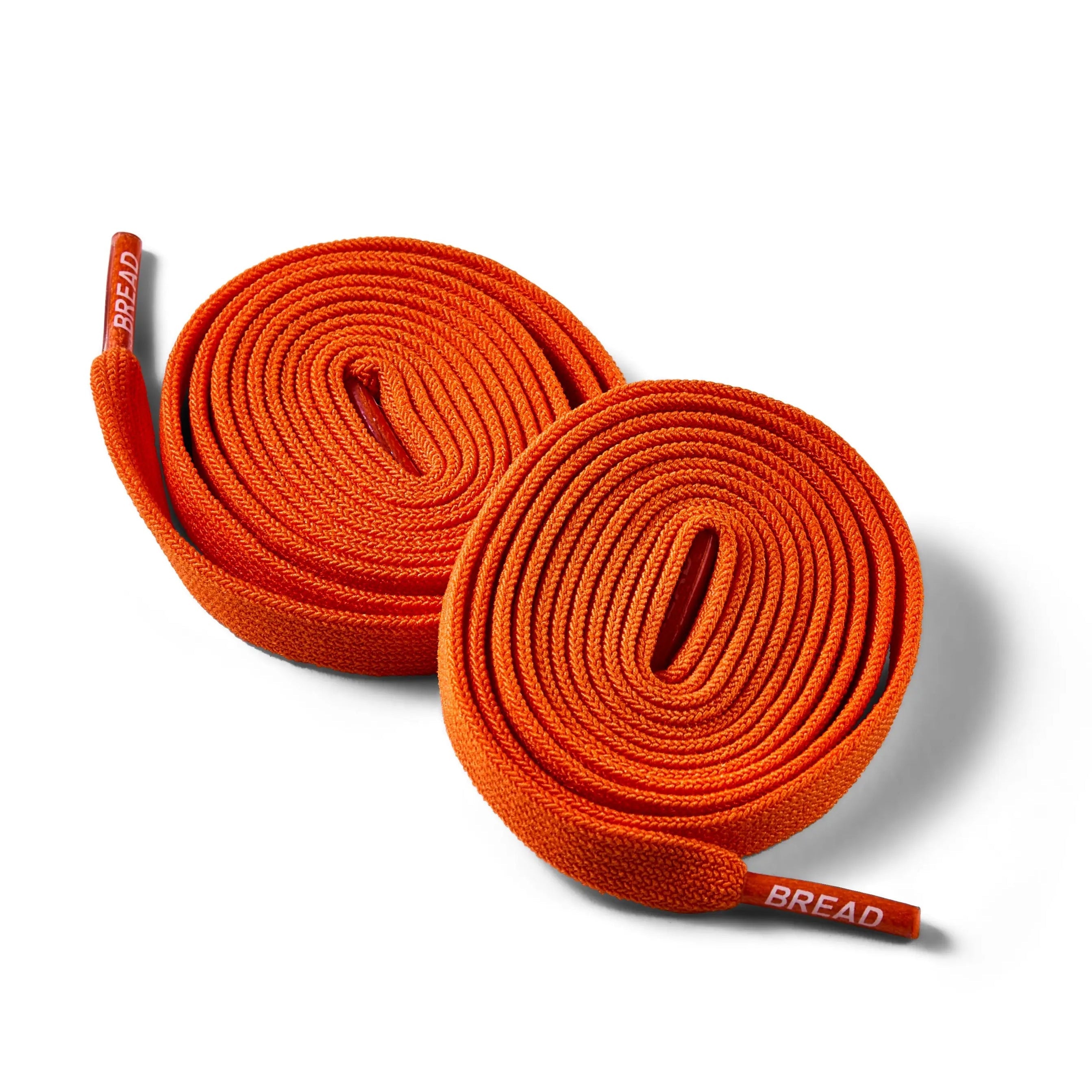 Coral orange elastic shoelace by Plush Fashion Hub, close-up view showing flexible, stretchable design for shoes.