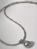 Elegant pearl pendant necklace featuring a single lustrous pearl on a delicate chain, crafted by Shopimist.