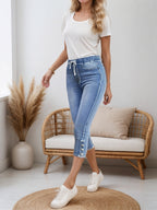 Women’s casual denim shorts with drawstring waist from FitiqueFit, shown on a model, featuring a relaxed fit and classic blue denim.