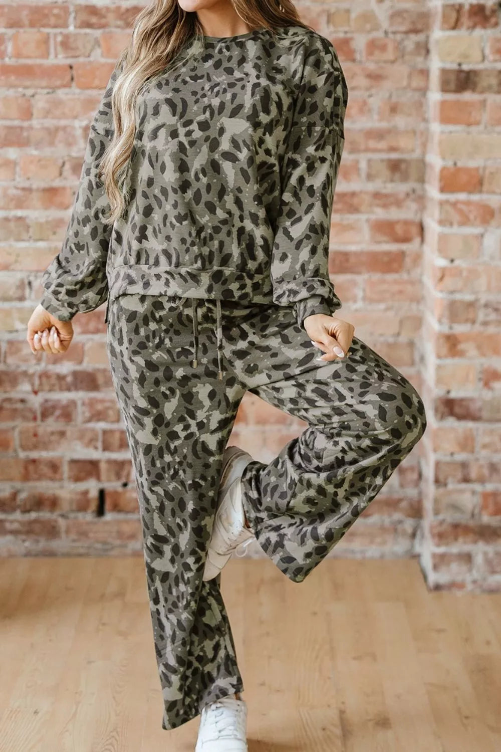 Leopard print long sleeve top and pants set by Trendsi, stylish matching set with bold animal print pattern.