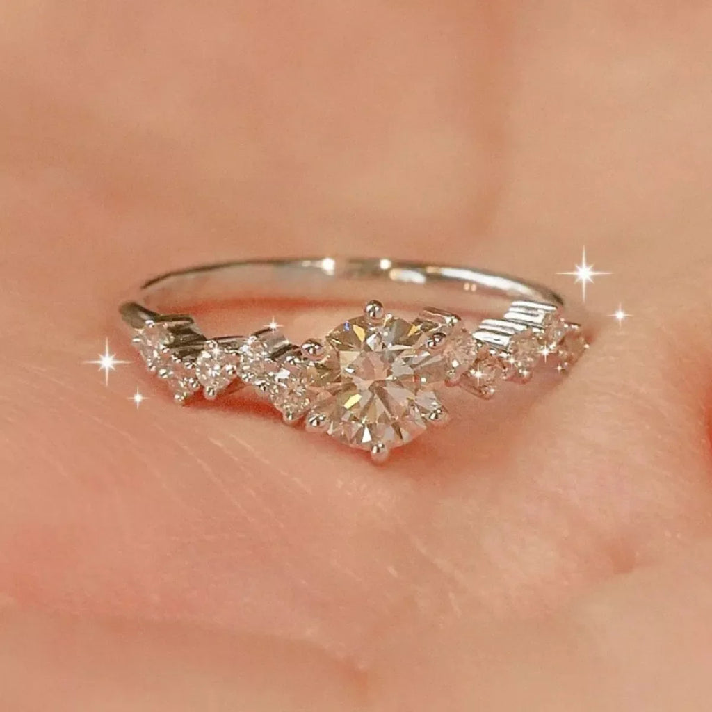 Sterling silver moissanite ring with 2 carats, featuring a sparkling center stone and intricate band design.