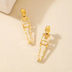Silver-tone Halloween skeleton earrings with 18K gold-plated finish, featuring detailed skeletal design for a spooky look.