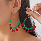 Christmas beaded hoop earrings with jingle bells, stylish festive jewelry by Shopimist, featuring colorful beads and holiday charm.