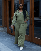 Green satin-lined jumpsuit by Plush Fashion Hub featuring a stylish, fitted design with long sleeves and a tapered pant leg.
