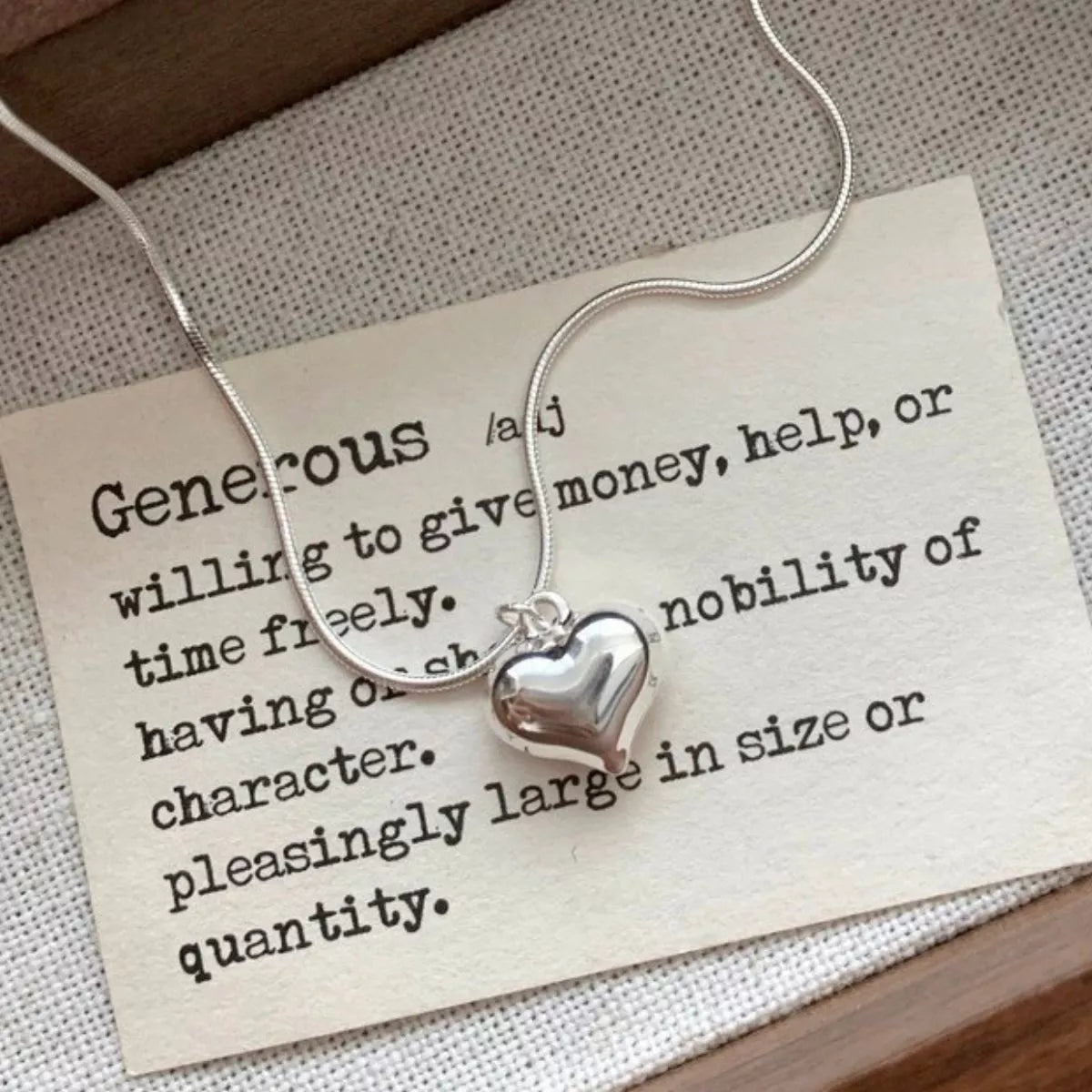 Sterling silver heart necklace with delicate chain from Plush Fashion Hub, close-up of the pendant on a white background.