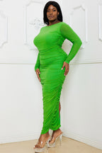 Green rhinestone mesh pleated plus size maxi dress by Fasheabe displayed on a model with flowing fabric and intricate detailing.