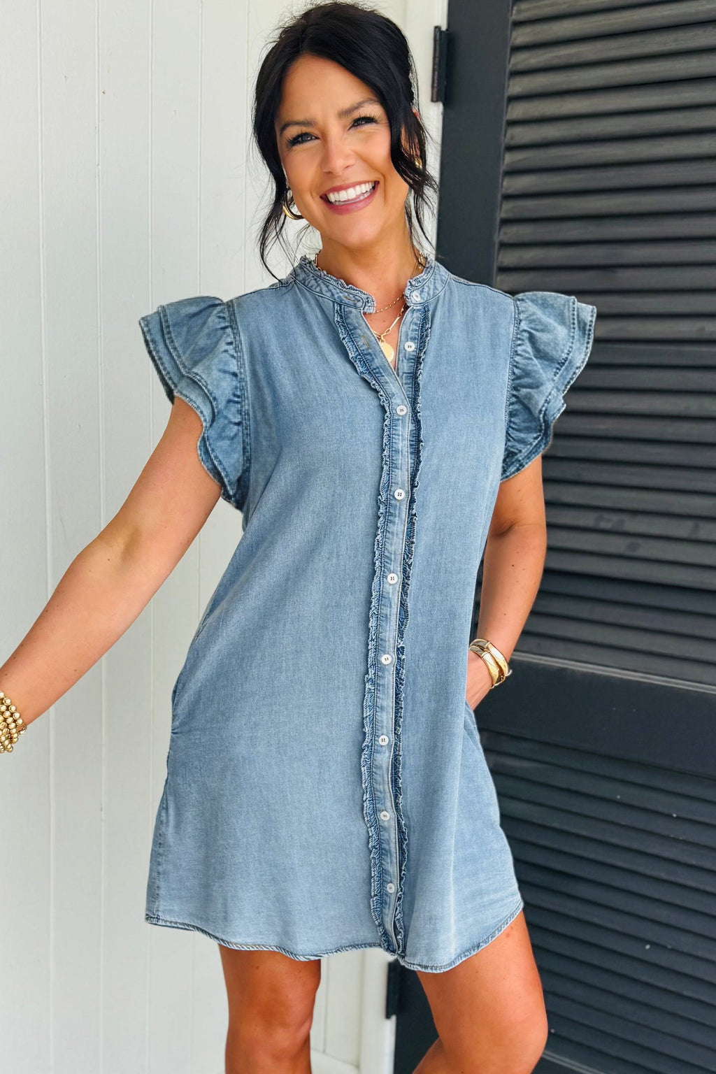Threaded Pear Sasha short sleeve mini dress displayed on a hanger with a soft, neutral background.