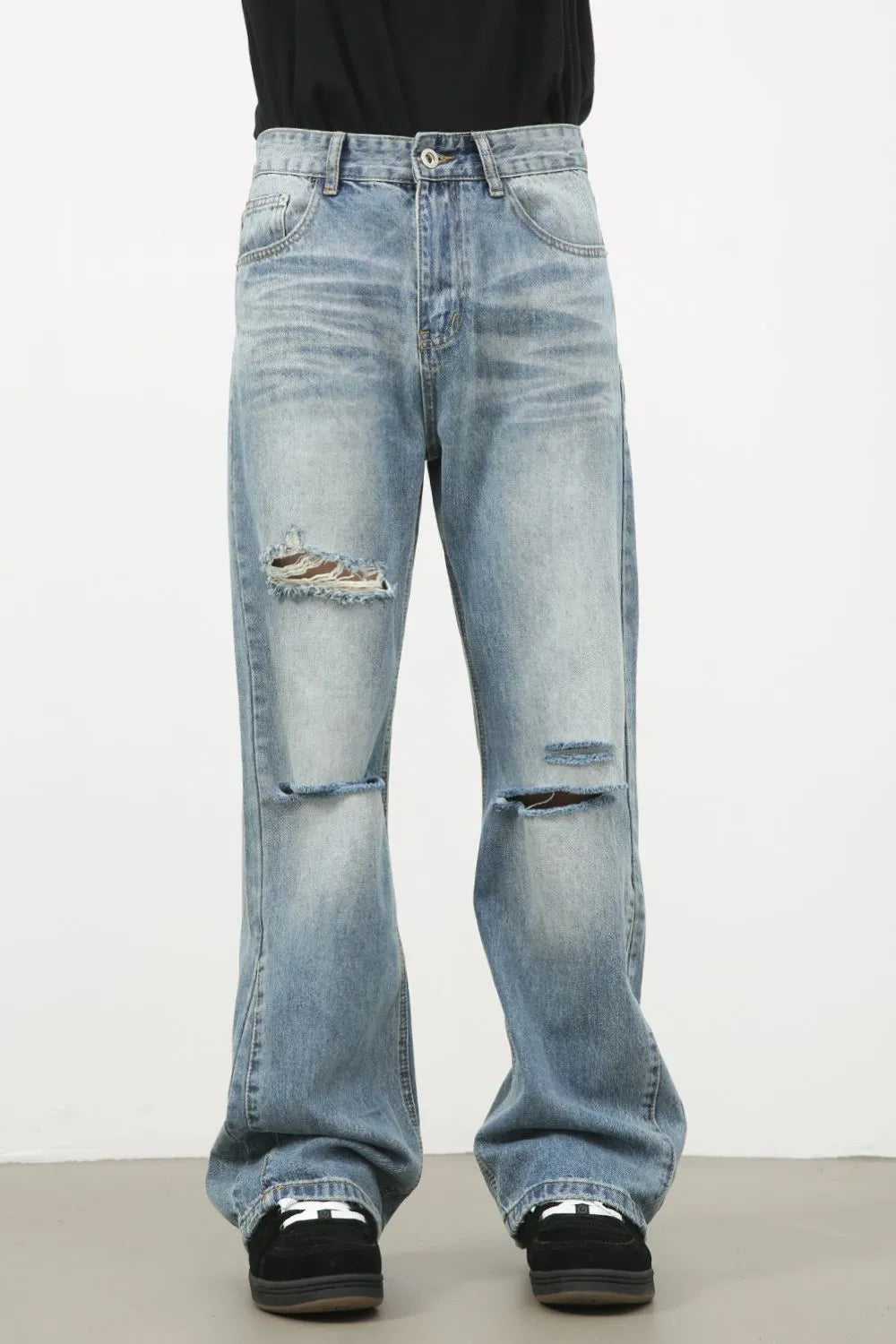 Men's distressed denim jeans from Plush Fashion Shop, showing faded and ripped details, casual fit with a classic blue wash.