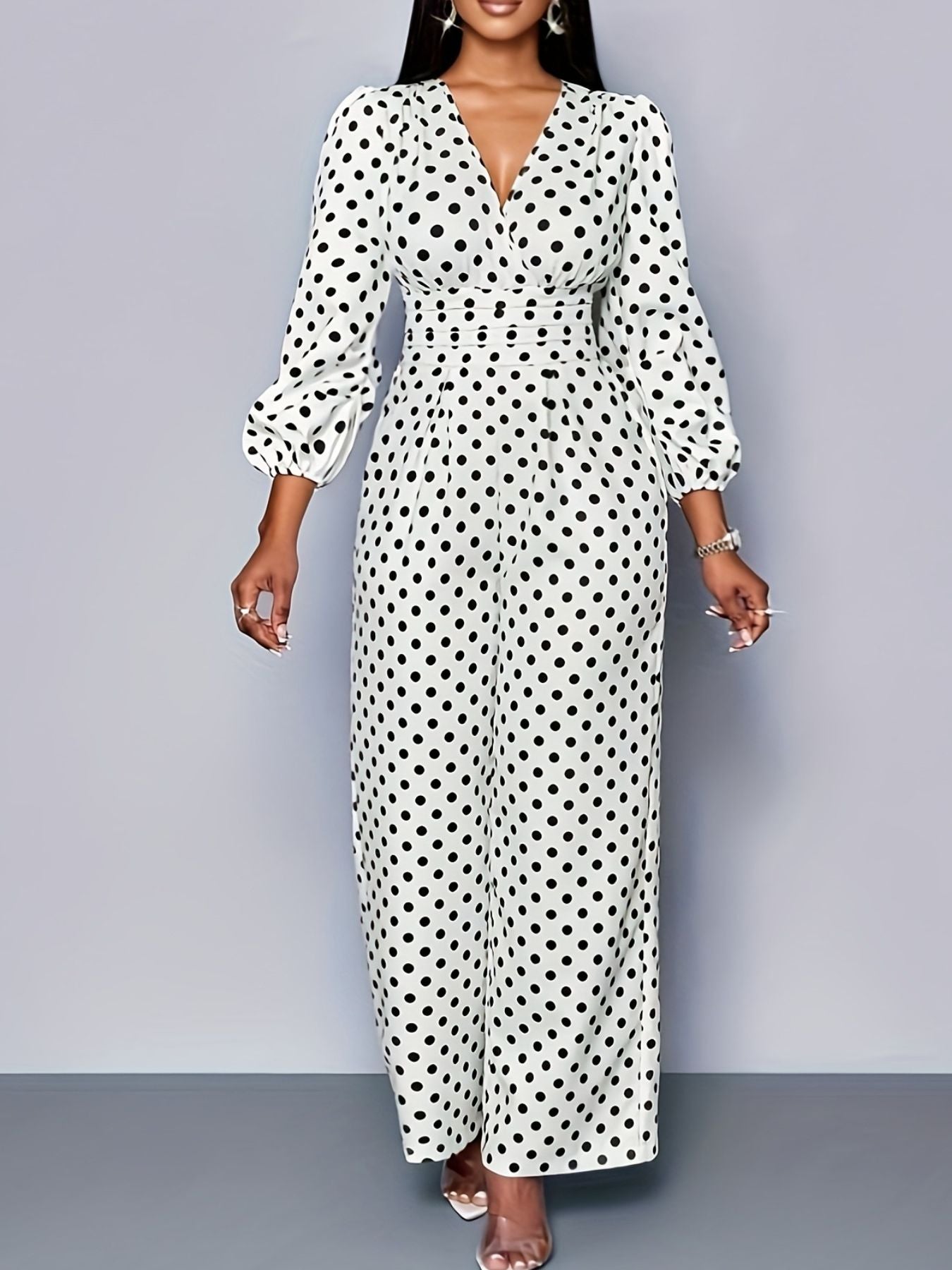 Women’s polka dot long sleeve jumpsuit with wide legs and pockets from Plush Fashion Hub, shown on a model.