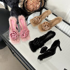 Three pairs of faux-fur high-heel sandals in pink, beige, and black, each featuring a large velvet rose embellishment.