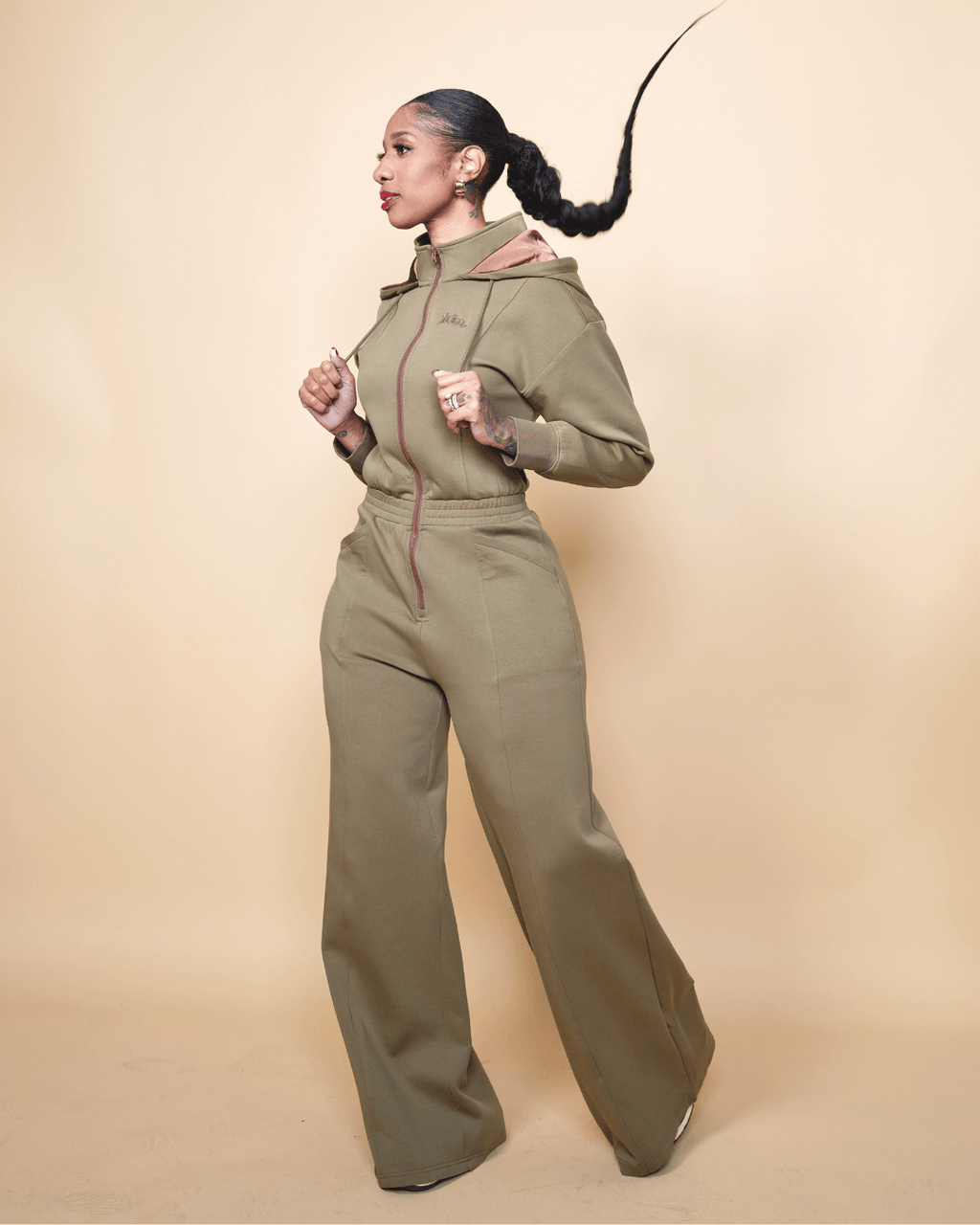 Green satin-lined jumpsuit by Plush Fashion Hub, featuring a stylish fit and smooth fabric, displayed on a hanger.