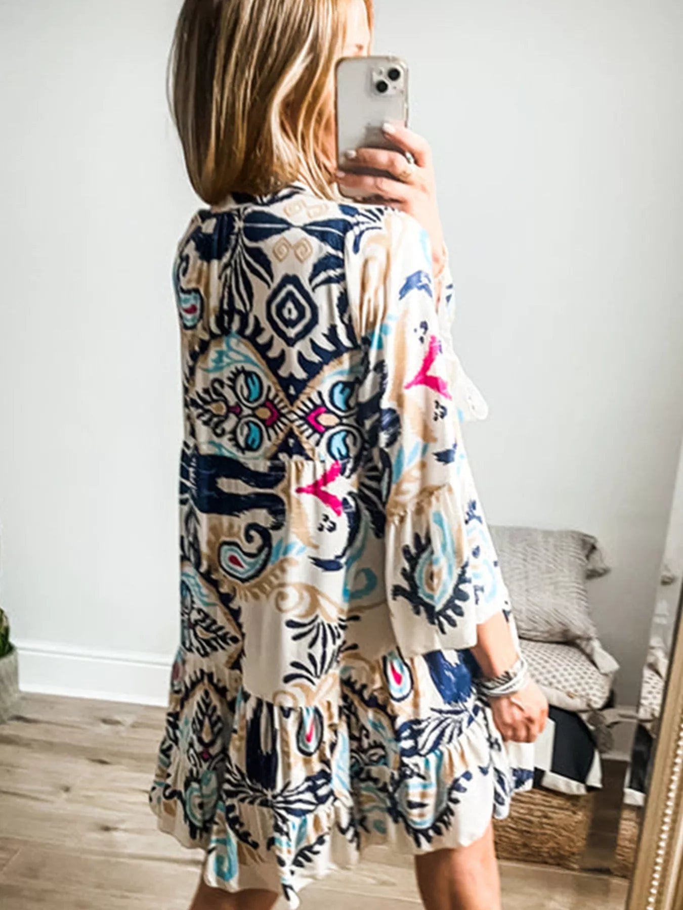Bohemian print tiered mini dress by Plush Fashion Hub featuring colorful patterns and flowing fabric.