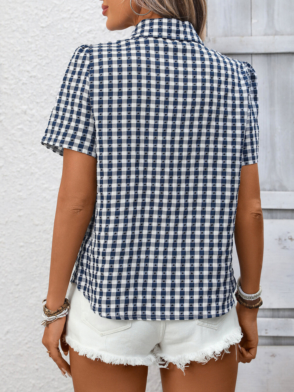 Women's lightweight plaid button-up short sleeve shirt by Trendsi, showcasing a casual, stylish design with a classic plaid pattern.