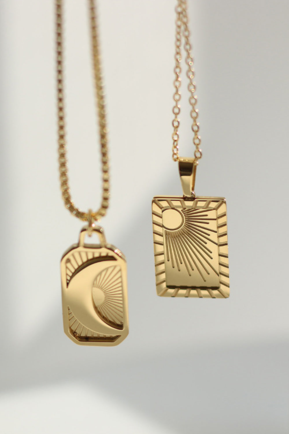 Stainless steel necklace with 18K gold plating, featuring a sleek and elegant design, displayed on a white background.