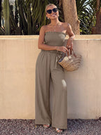Smocked strapless wide-leg jumpsuit by Plush Fashion Hub featuring a relaxed fit and stylish design, shown in a full-length view.