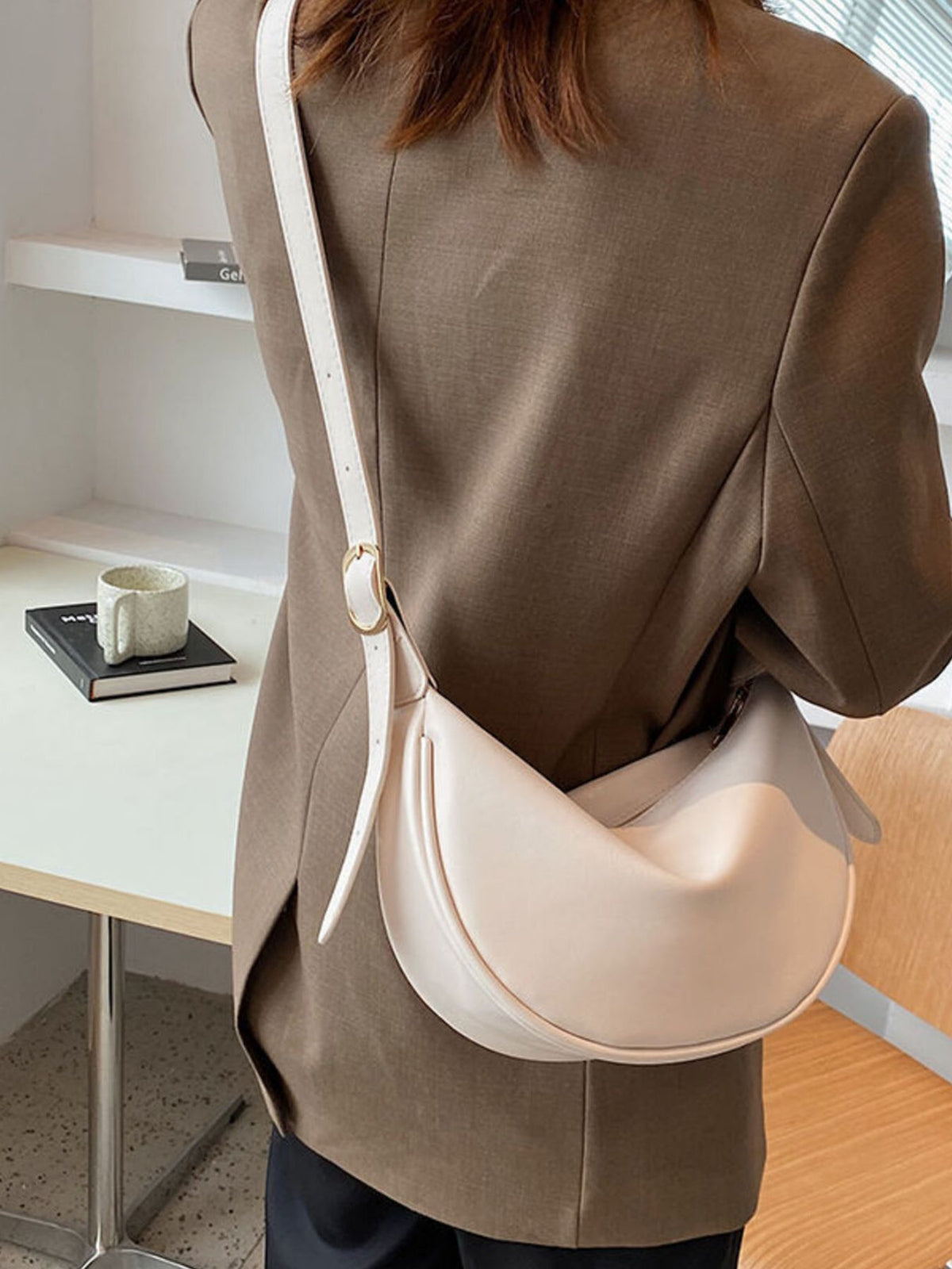 Minimalist Crescent crossbody bag in smooth PU leather from Plush Fashion Hub, showing sleek design and adjustable strap.