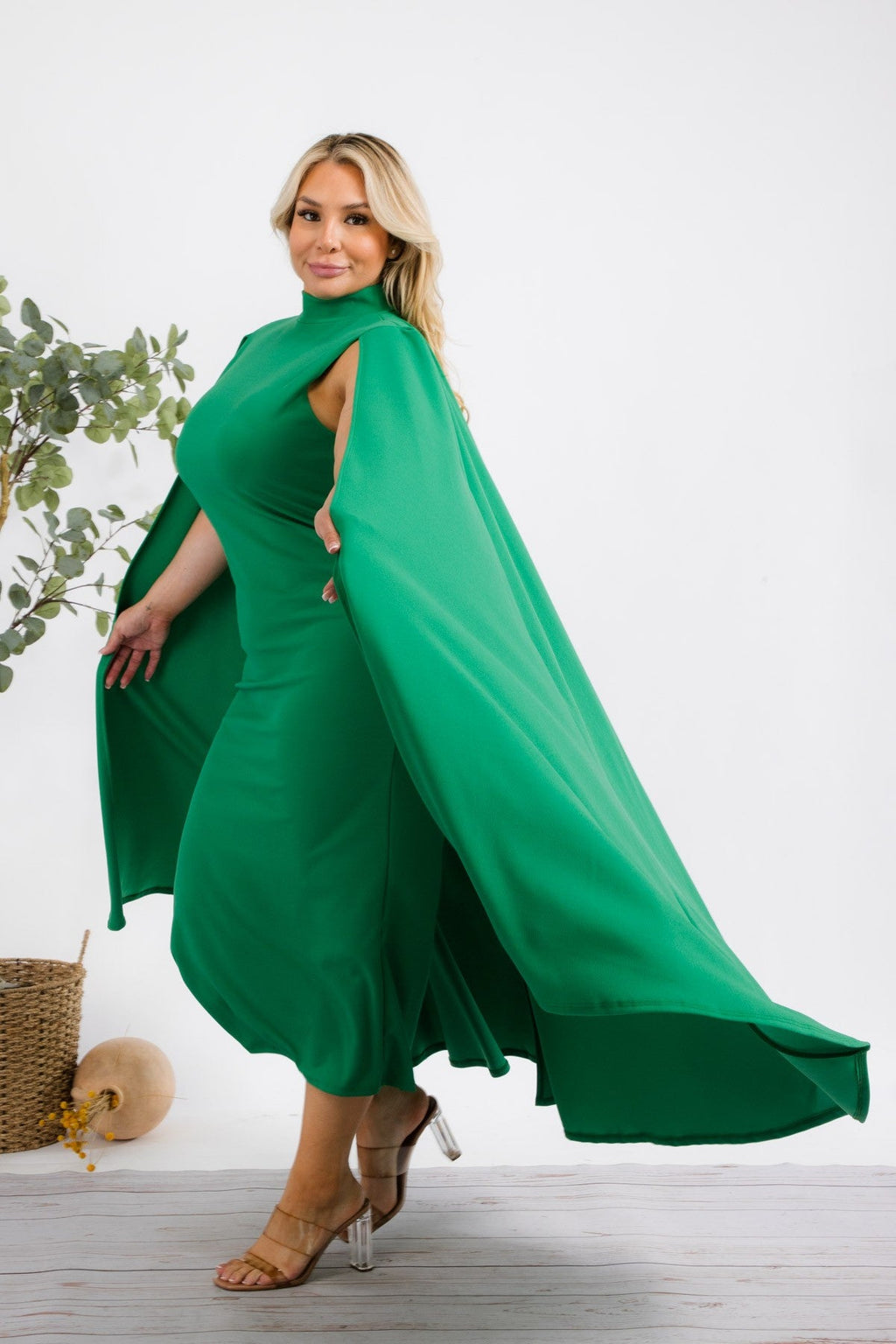 Plus size green midi dress from Fasheabe's Stella Cape collection, featuring flowing fabric and stylish cape detail.