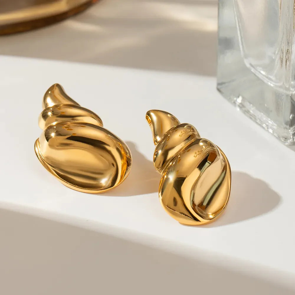 Gold-plated conch earrings with intricate detailing, showcasing plush fashion design and elegant jewelry style.