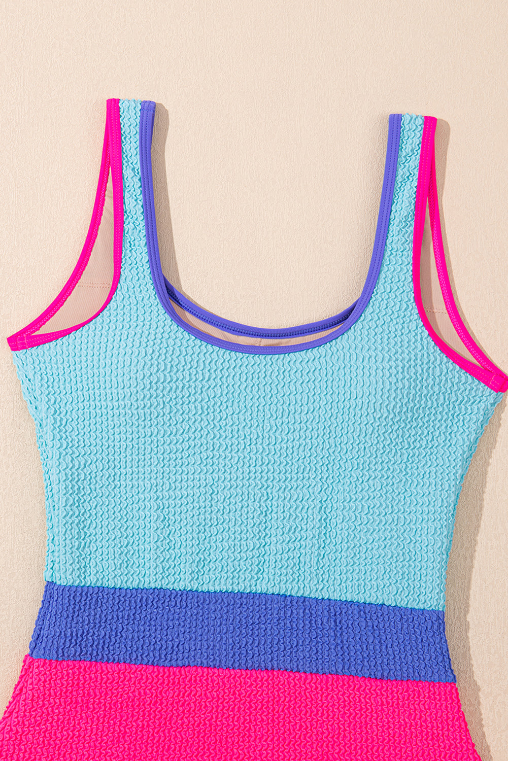 Threaded Pear Rory patchwork one-piece swimsuit with colorful geometric pattern, featuring a stylish cut and vibrant design.