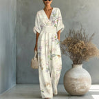 Women's waist-cinched V-neck printed wide-leg jumpsuit by FitiqueFit, featuring a casual, relaxed fit with a stylish pattern.