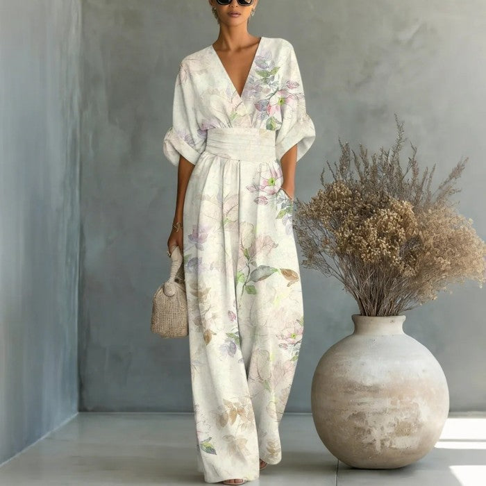 Women's waist-cinched V-neck printed wide-leg jumpsuit by FitiqueFit, featuring a casual, relaxed fit with a stylish pattern.