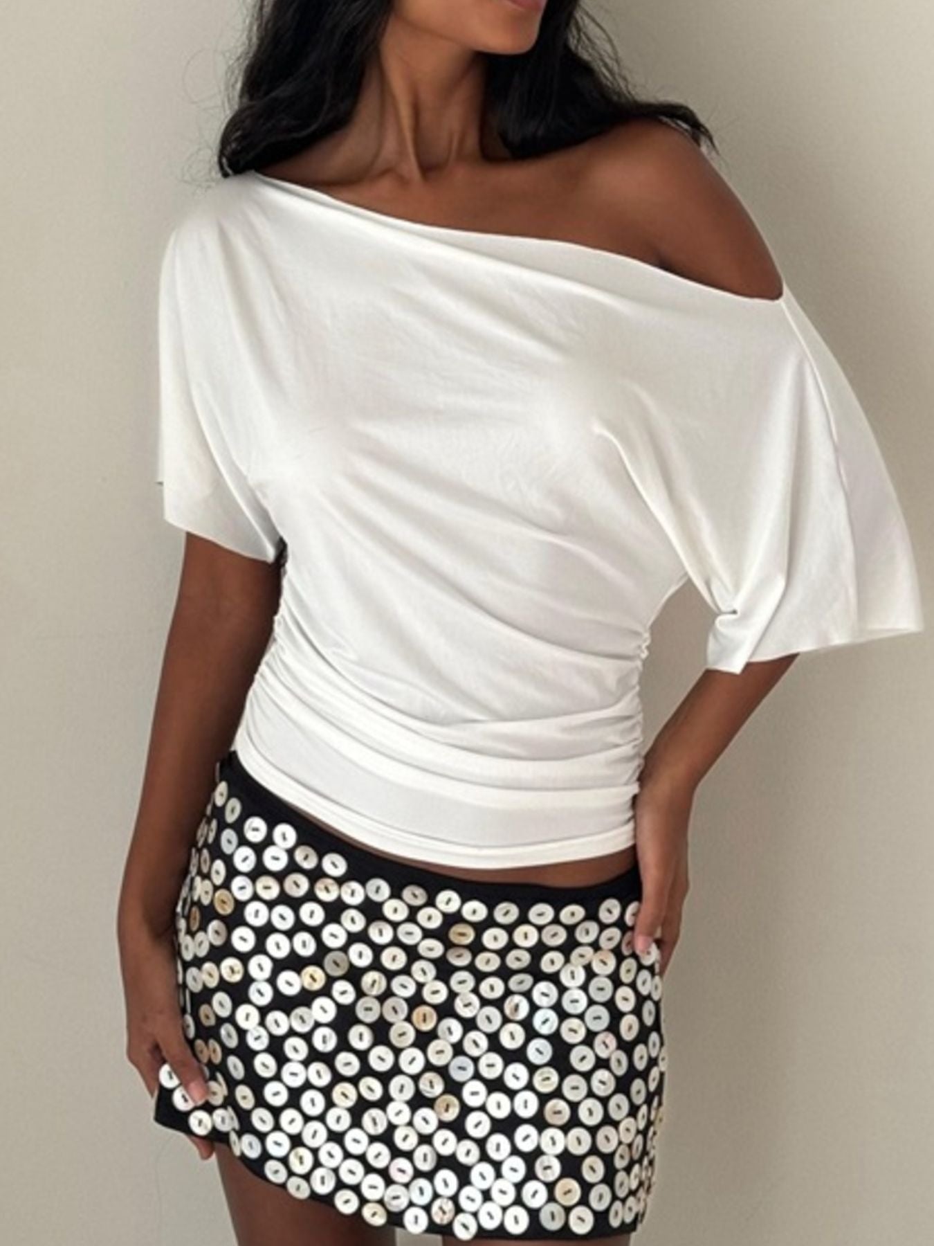 Women's one-shoulder ruched short sleeve T-shirt by Trendsi, featuring a chic stretch fabric and stylish design.