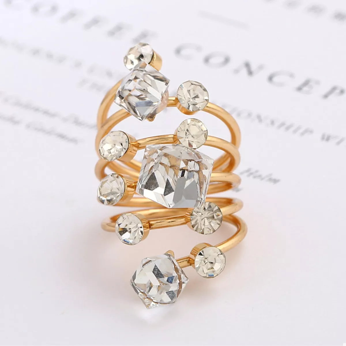 Gold-plated multi-layered ring with intricate design, featuring multiple bands and a polished finish, by Shopimist.