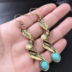 Alloy leaf-shaped turquoise earrings with intricate design, featuring vibrant blue stones and silver-toned metal for elegant wear.