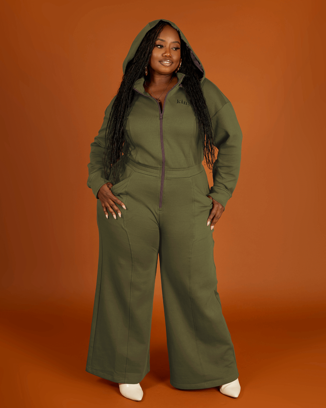 Green satin-lined jumpsuit by Plush Fashion Hub, featuring a sleek fit and stylish design, shown on a model.