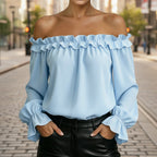 Women's ruffle off-shoulder blouse with 3/4 sleeves from Plush Fashion Hub, featuring elegant design and feminine ruffle details.
