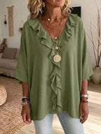 Plus size ruffle V-neck blouse with 3/4 sleeves from Trendsi, featuring a flowy fit and feminine ruffle details.