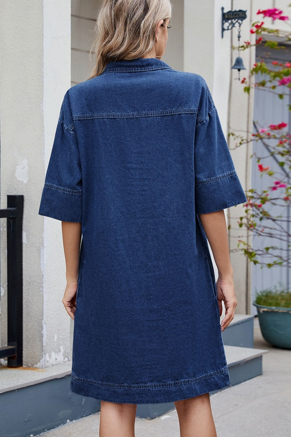 VYSN Johnny Collar half sleeve denim dress hanging on a rack, showcasing its collar and casual style.