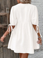 Cotton V-neck tie-front mini dress with puff sleeves, stylish and comfortable women's dress by Trendsi.