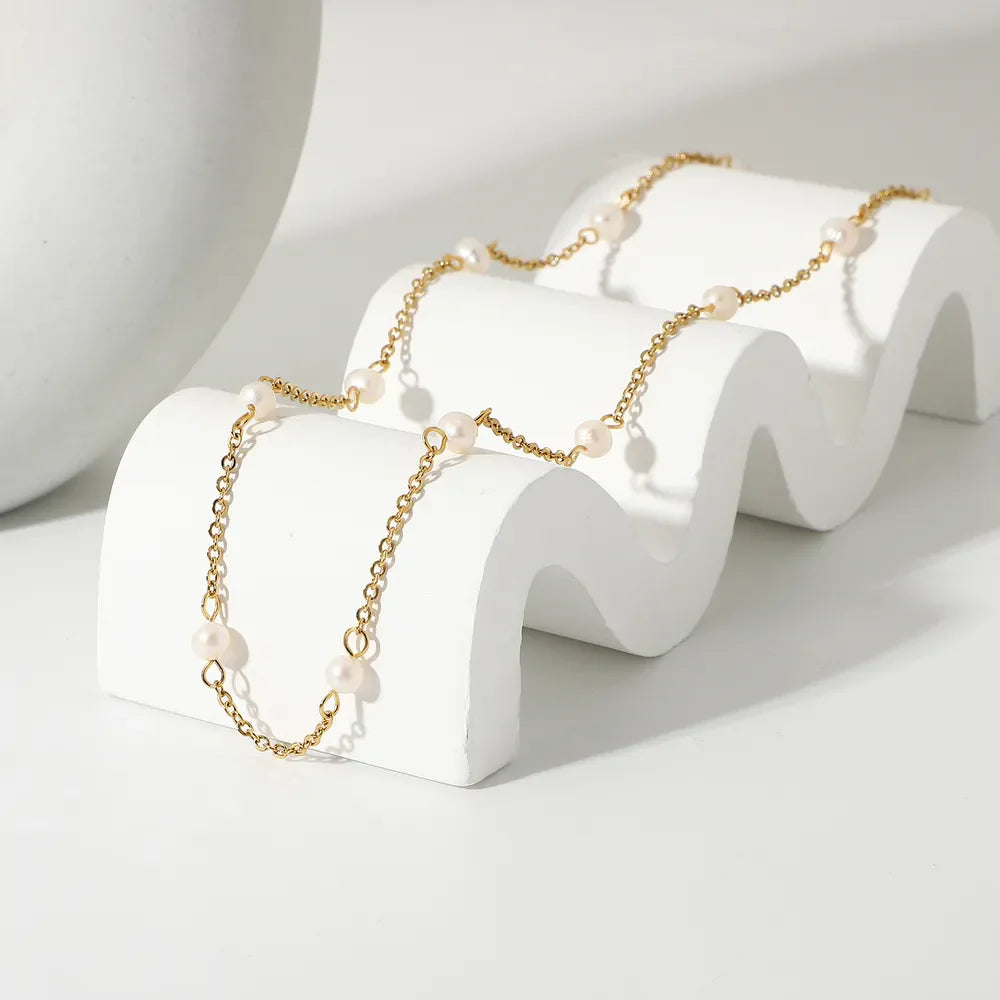 18K gold-plated freshwater pearl necklace with a delicate string and lustrous pearls, elegant jewelry piece from Plush Fashion Hub.