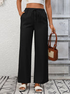 Women's high-waisted wide-leg drawstring pants in soft breathable viscose with relaxed fit and stylish design.