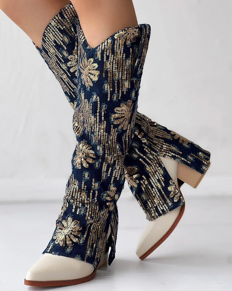 Knee-high denim boots featuring gold sequin floral patterns, chunky block heels, and pointy white toes.