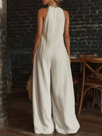 Plus size full size halter neck jumpsuit with lace trim, wide leg design, by Shopimist, shown in a stylish fashion pose.