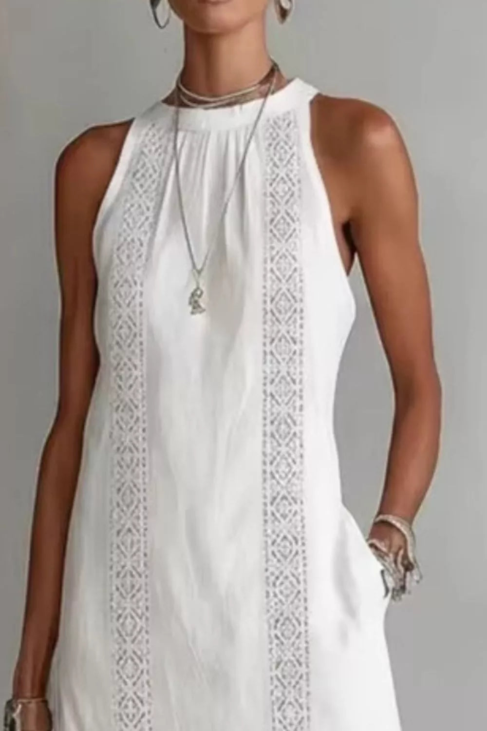 Women's sleeveless side slit maxi dress with pockets by Plush Fashion Hub, featuring a flowing silhouette and stylish design.
