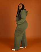 Green satin-lined jumpsuit by Plush Fashion Hub featuring long sleeves, a fitted waist, and wide-leg pants.