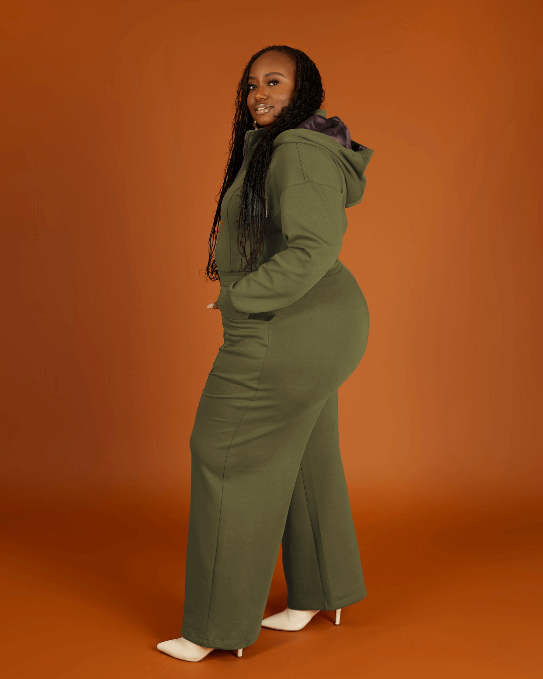 Green satin-lined jumpsuit by Plush Fashion Hub featuring long sleeves, a fitted waist, and wide-leg pants.