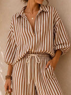 Plus size striped puff sleeve shirt and wide-leg drawstring pants set by Trendsi, featuring a casual, comfortable fit and stylish design.