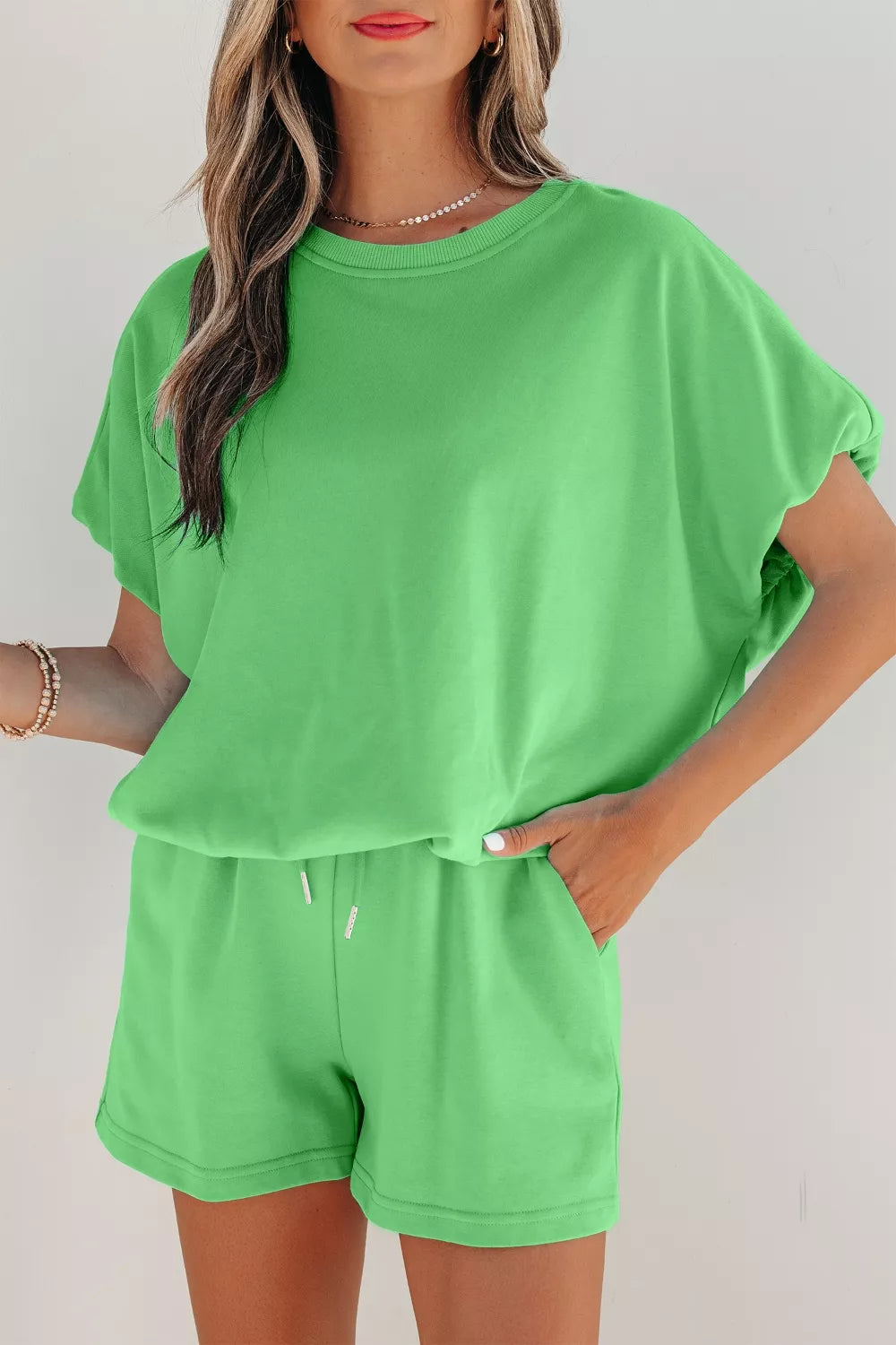 Pair of trendy solid color puffy loose drawstring shorts from Trendsi, shown in a 2-piece outfit with rings accessory.