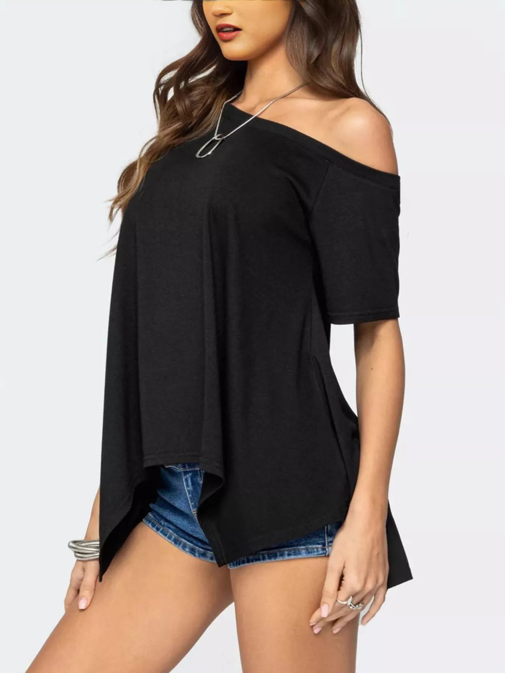 Women's off-shoulder asymmetrical flowy T-shirt in soft fabric, stylish tops by Trendsi, featuring a relaxed fit and unique design.